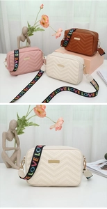 Detail of chevron quilted camera bag featuring a colorful LOVE print wide strap