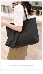 Close-up of black quilted tote bag with matching pouch in a modern cafe setting
