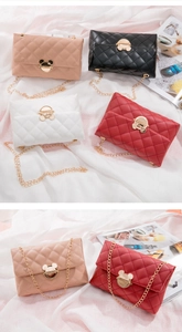 Detail of colorful quilted crossbody bags with golden mouse-shaped metal buckles