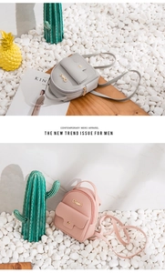 Close-up of pink and grey mini backpacks in pebble grain leather with adjustable straps