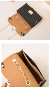 Detail view of the vintage chain flap bag interior and golden rotary lock mechanism