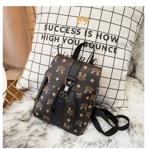 Detail of printed brown leather mini backpack with metal buckle and drawstring closure
