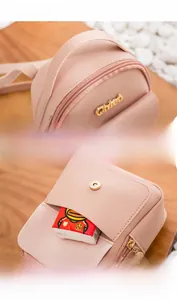 Detail of pink mini backpack featuring reinforced handle and magnetic front pocket