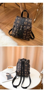 Detail of vintage brown printed backpack with metal buckle and drawstring closure