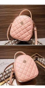 Close-up of pink quilted crossbody bag featuring a golden flower logo and PU leather texture