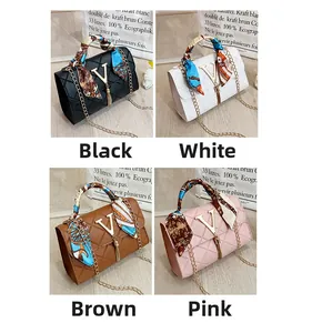 Detail view of four-color quilted bags with V-shaped metal buckles and silk scarf handles