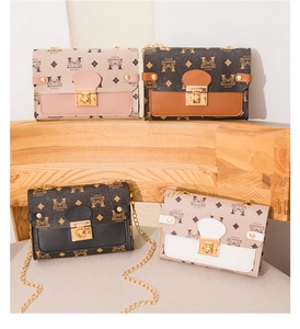 Close-up of four chain crossbody bags with diamond pattern and gold metal locks