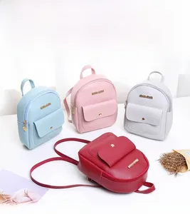 Detailed shot of stylish mini PU leather backpacks in blue, pink, grey and red colors