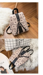 Detailed view of mini printed backpack with metal buckle closure on a fur rug