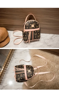 Detailed view of mini retro monogram backpack with pink leather trim and striped strap