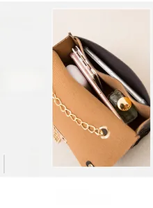 Interior view showing the large capacity of the caramel brown leather chain flap bag