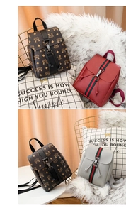 Detail of mini backpack showing drawstring closure, buckle flap, and striped ribbon accent