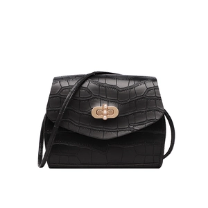 Elegant black crocodile pattern crossbody bag with pearl gold buckle on white background