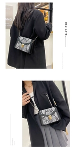 Detail showing snake pattern texture and golden metal lock on a crossbody bag