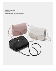 Minimalist leather crossbody bags with pearl charms in pink, white, and black colors