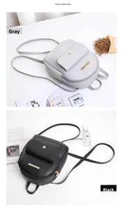 Detail view of mini PU leather backpacks in grey and black with gold hardware accents