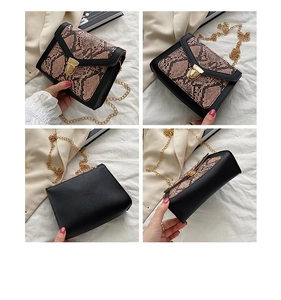 Detail view of small square crossbody bag with snake print flap and gold metal chain strap