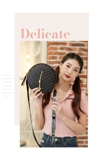 Close-up of black V-quilted round crossbody bag with golden tassel and patterned strap