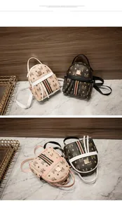 Close-up of mini monogrammed backpack with signature stripe and gold metal buckle