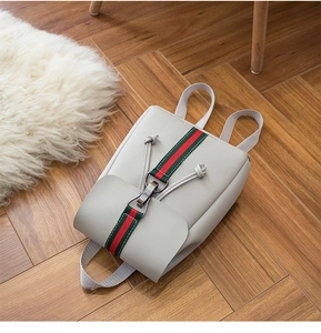 Close-up of light grey fashion backpack with green and red striped ribbon and metal buckle