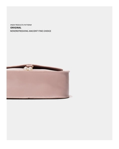 Detailed macro view of pink leather handbag featuring elegant dual pearl metal clasps