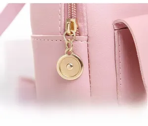 Detail shot of smooth pink PU leather texture and premium gold-toned metal zipper hardware