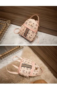 Detail of pink mini backpack with letter print, tricolor ribbon and gold metal plate