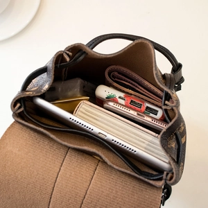 Brown monogram printed bucket backpack with spacious interior for tablets and phones