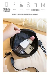 Interior view of round black crossbody bag with shoulder strap showing daily essentials