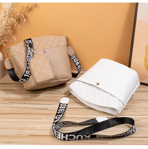 Detail view of quilted bucket bags with wide woven straps and mini coin pouch accessory