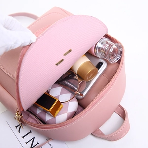 Pink minimalist leather backpack showing interior storage capacity for daily essentials