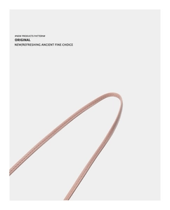 Detailed close-up of light pink leather shoulder strap with premium double stitching