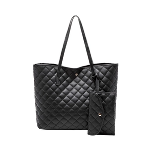 Black quilted tote bag with matching small pouch featuring elegant gold metal hardware