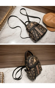 Detail of mini backpack with vintage monogram print and tricolor stripe ribbon decor