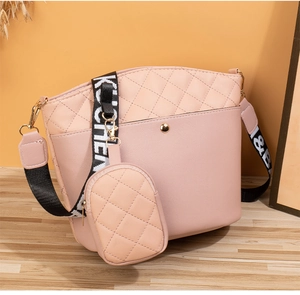 Pink bucket bag and mini pouch detail with stylish patterned wide shoulder strap