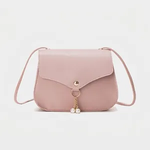 Minimalist dusty pink PU leather crossbody bag with elegant gold pearl charm detail