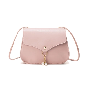 Pink minimalist crossbody bag with envelope flap and gold pearl charm on white background