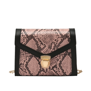 Pink snakeskin patterned crossbody bag with black trim and gold chain strap in main view