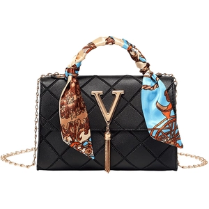 Black quilted crossbody bag with gold V logo, tassel pendant and printed handle scarf