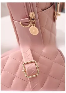 Detail showing the customized gold zipper and adjustable shoulder strap of the pink bag