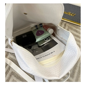 Interior view of white crocodile texture backpack showing storage capacity for daily essentials