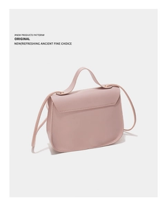 Detail view of pink leather crossbody bag showing stitching and side profile