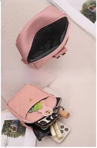 Pink quilted phone bag showing multi-compartment storage for phone and cosmetics