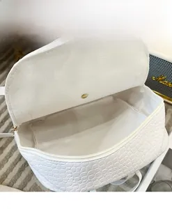Detailed view of the spacious interior compartment of the white crocodile texture backpack