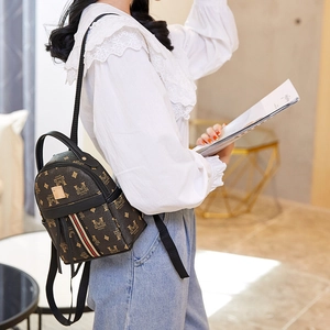 Mini vintage backpack with brown monogram pattern and striped webbing on casual model