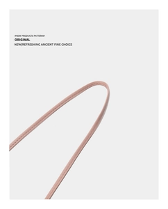 Close-up of pink leather shoulder strap detail with high-quality fine stitching