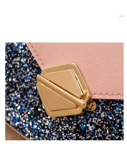 Detailed macro view of the golden hexagonal lock and sparkling sequin texture on a pink bag