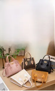 Detail showing five mini Kelly-style bags in various checkered patterns and colors