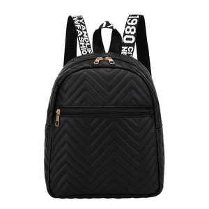 Black quilted backpack for women featuring embroidered wave patterns and ribbon straps
