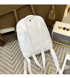 Close-up of white crocodile pattern backpack back with textured shoulder straps